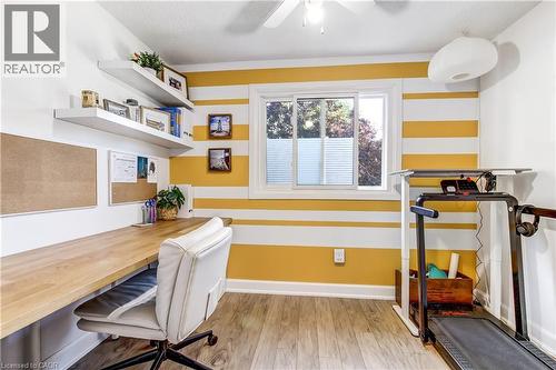 Dedicated space featuring wood-finish flooring, a built-in desk, and two floating shelves - 218 Richardson Drive Unit# 26, Port Dover, ON 