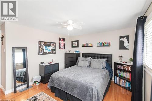 Bright room featuring hardwood-finish flooring, a ceiling fan, and window blinds - 366 Berkindale Drive, Hamilton, ON 