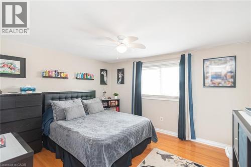 Hardwood flooring, neutral wall tones, and crown molding define this bedroom - 366 Berkindale Drive, Hamilton, ON 