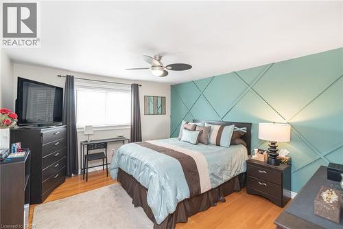 Feature wall with geometric paneling and a ceiling fan with integrated lighting - 366 Berkindale Drive, Hamilton, ON 