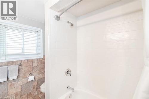 Shower-over-tub combination with white subway tile surround, chrome fixtures, and a curved shower rod - 366 Berkindale Drive, Hamilton, ON 
