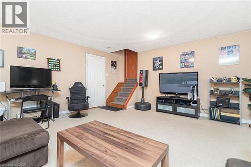 Carpeted recreation room featuring neutral wall paint and a flush-mount ceiling light - 366 Berkindale Drive, Hamilton, ON 