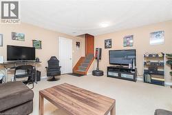 Carpeted recreation room featuring neutral wall paint and a flush-mount ceiling light - 