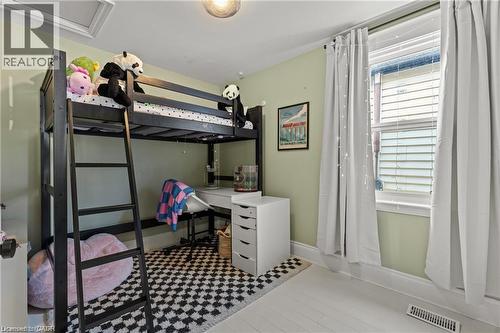 Room featuring light green painted walls and white wood-finish flooring - 33 Huxley Avenue N, Hamilton, ON 