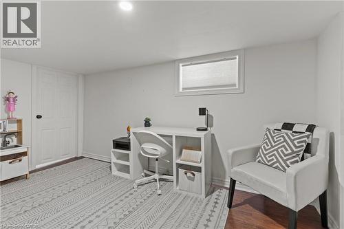 Finished room with recessed lighting and warm-toned wood-finish flooring - 33 Huxley Avenue N, Hamilton, ON 