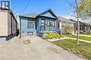 Blue siding exterior with contrasting black trim - 33 Huxley Avenue N, Hamilton, ON 