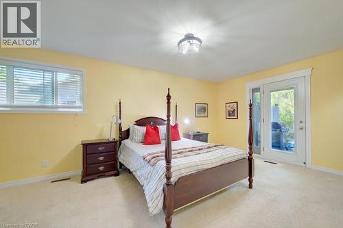 Carpeted room with a large window and double glass doors - 60 Mayfield Avenue, Waterloo, ON 
