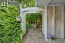 White lattice archway opening to a paver patio - 60 Mayfield Avenue, Waterloo, ON 