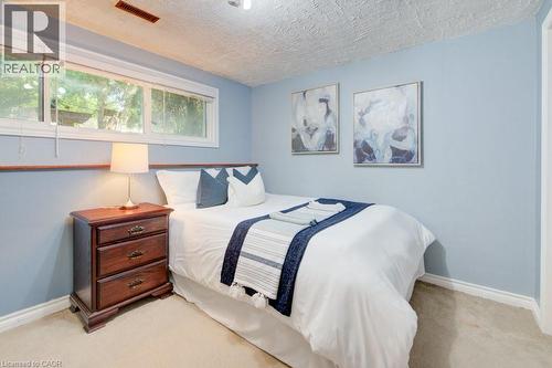 Bedroom with neutral carpet flooring and light blue walls - 60 Mayfield Avenue, Waterloo, ON 
