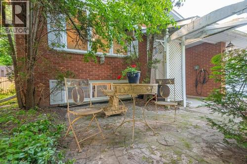 Exterior brick wall with white window trim and a stone window sill - 60 Mayfield Avenue, Waterloo, ON 