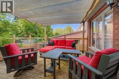 Spacious wood-finish deck with a fabric shade canopy - 60 Mayfield Avenue, Waterloo, ON 