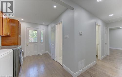 Utility area with wood-finish flooring, recessed lighting, and a paneled entry door with sidelight - 80 Lower Canada Crescent, Kitchener, ON 