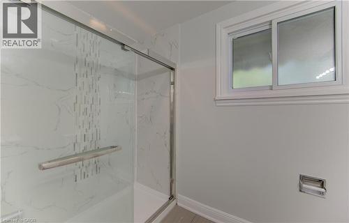 Enclosed shower with clear glass sliding door featuring a brushed metal handle - 80 Lower Canada Crescent, Kitchener, ON 