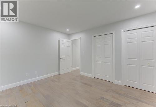 Light-toned wood-finish flooring complements the neutral wall color and white trim - 80 Lower Canada Crescent, Kitchener, ON 