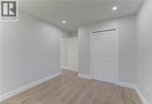 Interior room featuring wood-finish flooring, recessed lighting, and a bi-fold closet door - 80 Lower Canada Crescent, Kitchener, ON 