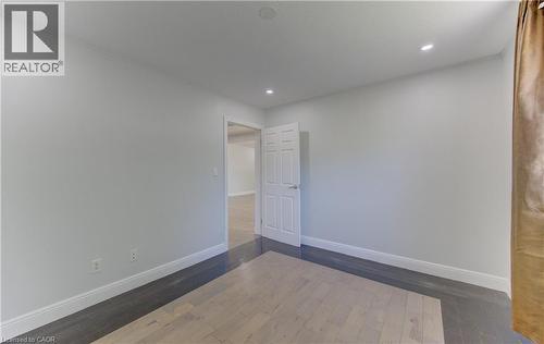Bright room featuring light wood-finish flooring, white baseboards, and recessed lighting - 80 Lower Canada Crescent, Kitchener, ON 