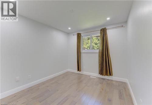 Bright room with light wood-finish flooring and a white window frame - 80 Lower Canada Crescent, Kitchener, ON 