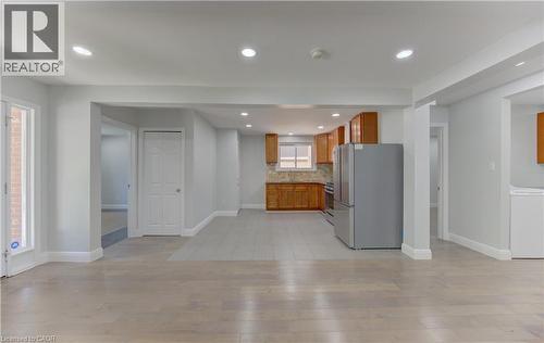 Open-concept living space featuring light wood-finish flooring, recessed lighting, and neutral wall tones - 80 Lower Canada Crescent, Kitchener, ON 