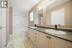 Double vanity with integrated sinks, dark countertops, and matte black fixtures - 