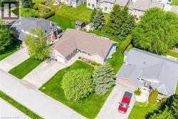 Aerial view showcasing a residential property with a brown shingle roof and an attached two-car garage - 