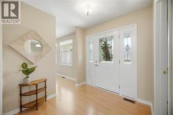 Entryway featuring a white door with decorative glass inserts and two sidelights - 
