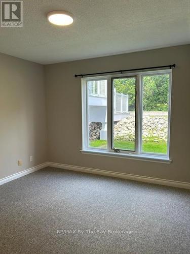 Second bdrm, new carpet and light fixture - 1 - 10 Mulligan Lane, Wasaga Beach, ON - Indoor Photo Showing Other Room