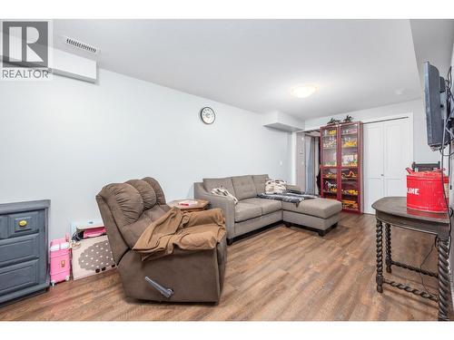 Recreation area in basement with access to storage area and outside door. - 6596 Lavington Way, Coldstream, BC 
