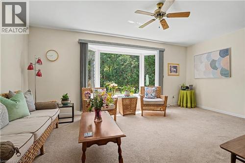Living area featuring a spacious bay window, ceiling fan, and neutral carpet flooring - 2068 Wellington Avenue, Burlington, ON 
