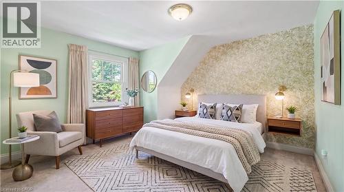 Bedroom featuring a prominent window, sloped ceiling detail, and patterned accent wall - 2068 Wellington Avenue, Burlington, ON 