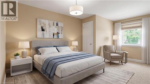 Neutral-toned bedroom featuring a light gray upholstered bed frame and a contrasting area rug - 2068 Wellington Avenue, Burlington, ON 