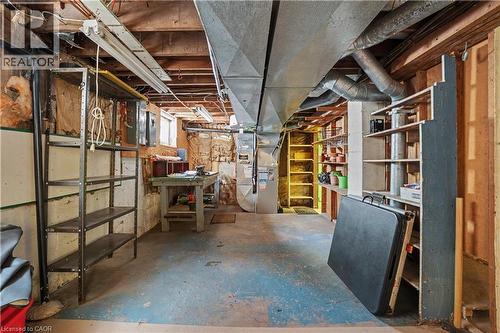Unfinished basement space featuring exposed wood joists, structural beams, and concrete flooring - 2068 Wellington Avenue, Burlington, ON 