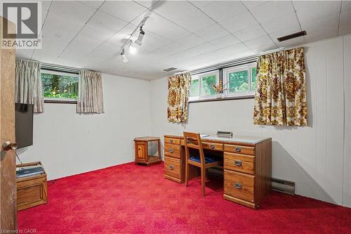 Room featuring bright red carpeting, white paneled walls, and a drop ceiling with track lighting - 2068 Wellington Avenue, Burlington, ON 