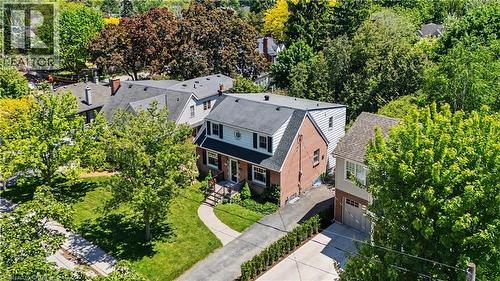 Traditional two-story residence featuring a brick exterior and a side-gabled roof - 2068 Wellington Avenue, Burlington, ON 