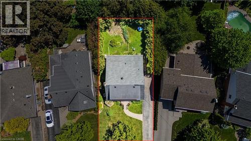 Expansive lot featuring a shingle roof residence, a substantial paved driveway, and manicured landscaping - 2068 Wellington Avenue, Burlington, ON 