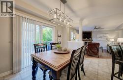 Dining area with tile flooring and a multi-light linear chandelier - 