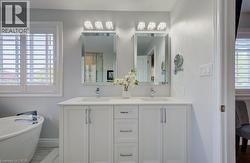 Dual vanity with white cabinetry, integrated sinks, chrome faucets, and quartz countertop - 