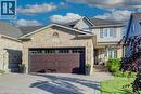 Brick and siding exterior featuring a two-car garage with glass-paneled doors, an arched entryway, and a covered porch with white columns - 7 Housler Lane, Cambridge, ON 