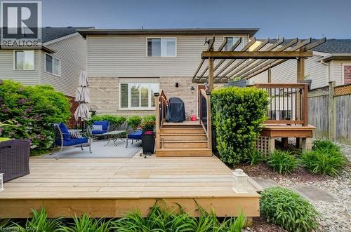 Multi-level wooden deck featuring a built-in pergola and staircase - 7 Housler Lane, Cambridge, ON 