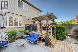 Multi-level outdoor decking with pergola, wood planking, and black metal railings - 