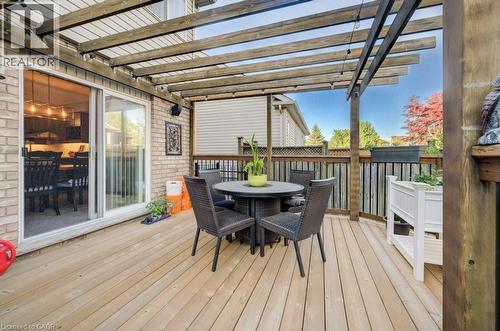 Expansive wood-finish deck featuring a wood pergola and privacy fencing - 7 Housler Lane, Cambridge, ON 