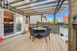 Expansive wood-finish deck featuring a wood pergola and privacy fencing - 