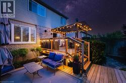 Multi-level outdoor deck featuring a wooden pergola with string lighting - 