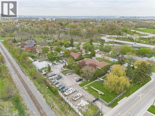 Expansive property featuring a commercial building, a large parking area, and a substantial fenced green space - 262-270-276 Hixon Road, Hamilton, ON 