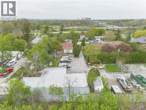 Commercial property featuring a large metal-clad building, expansive paved lot, and perimeter fencing - 262-270-276 Hixon Road, Hamilton, ON 