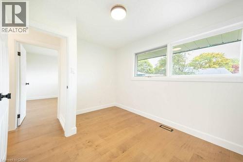 Room featuring light wood-finish flooring, white walls, and bright overhead lighting - 22 Charlotte Crescent, Kitchener, ON 