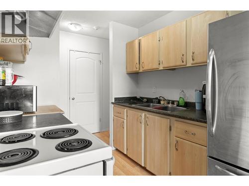 Functional kitchen with ample cabinet space, easy flow to the dining area, and convenient bonus in-suite storage nearby. - 555 Dalgleish Drive Unit# 412, Kamloops, BC - Indoor Photo Showing Kitchen With Double Sink