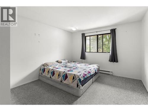 Spacious bedroom featuring large window for natural light, comfortable layout, and plenty of room for additional furniture or workspace. - 555 Dalgleish Drive Unit# 412, Kamloops, BC - Indoor Photo Showing Bedroom