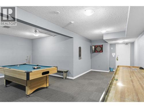 Games room with pool table, shuffleboard, and entertainment space for residents and guests to enjoy. - 555 Dalgleish Drive Unit# 412, Kamloops, BC - Indoor Photo Showing Other Room