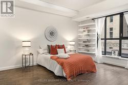 Spacious primary bedroom with large windows - 