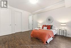Spacious primary bedroom with large windows - 